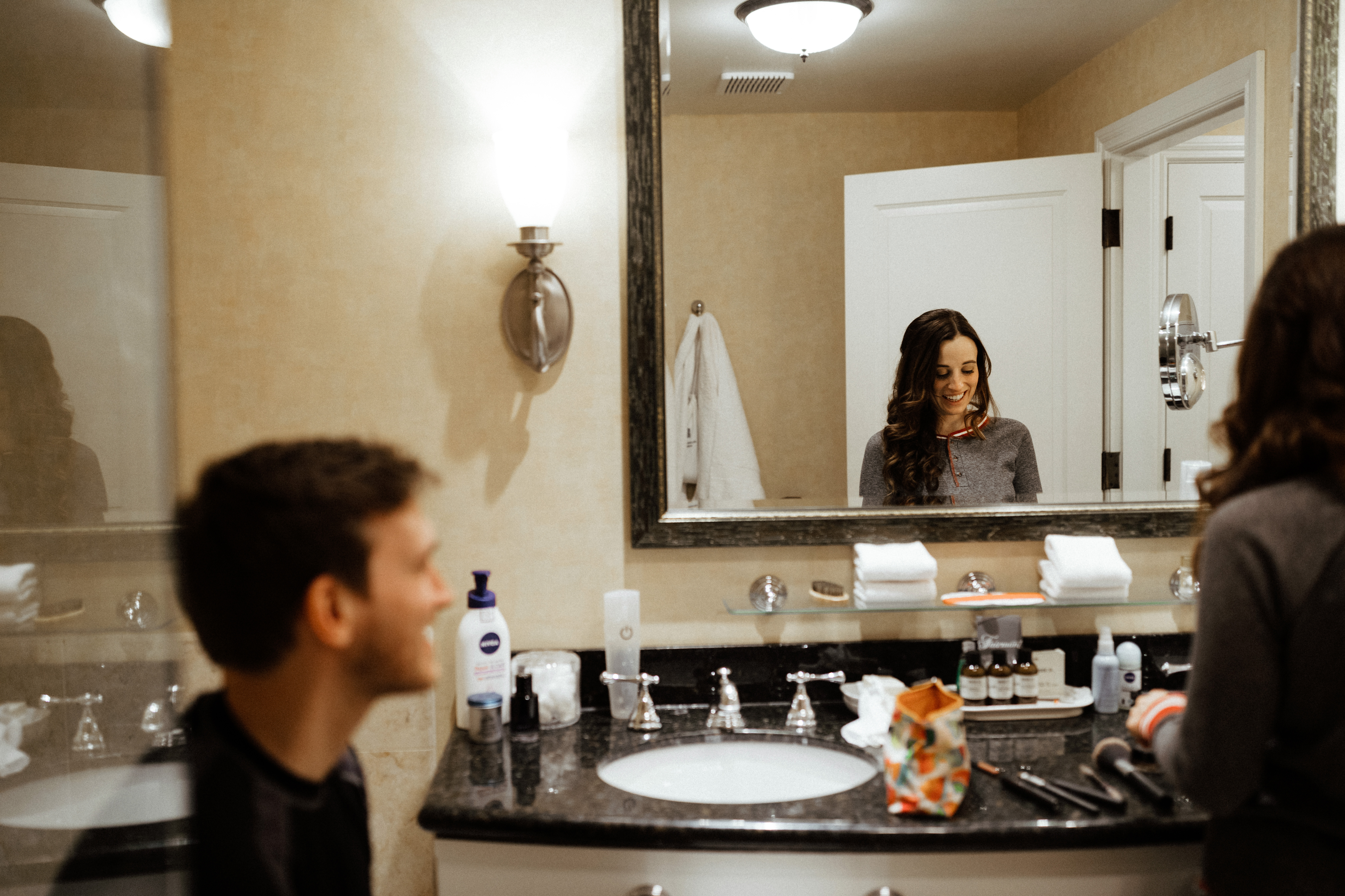 couple get ready together in the bathroom on their wedding day