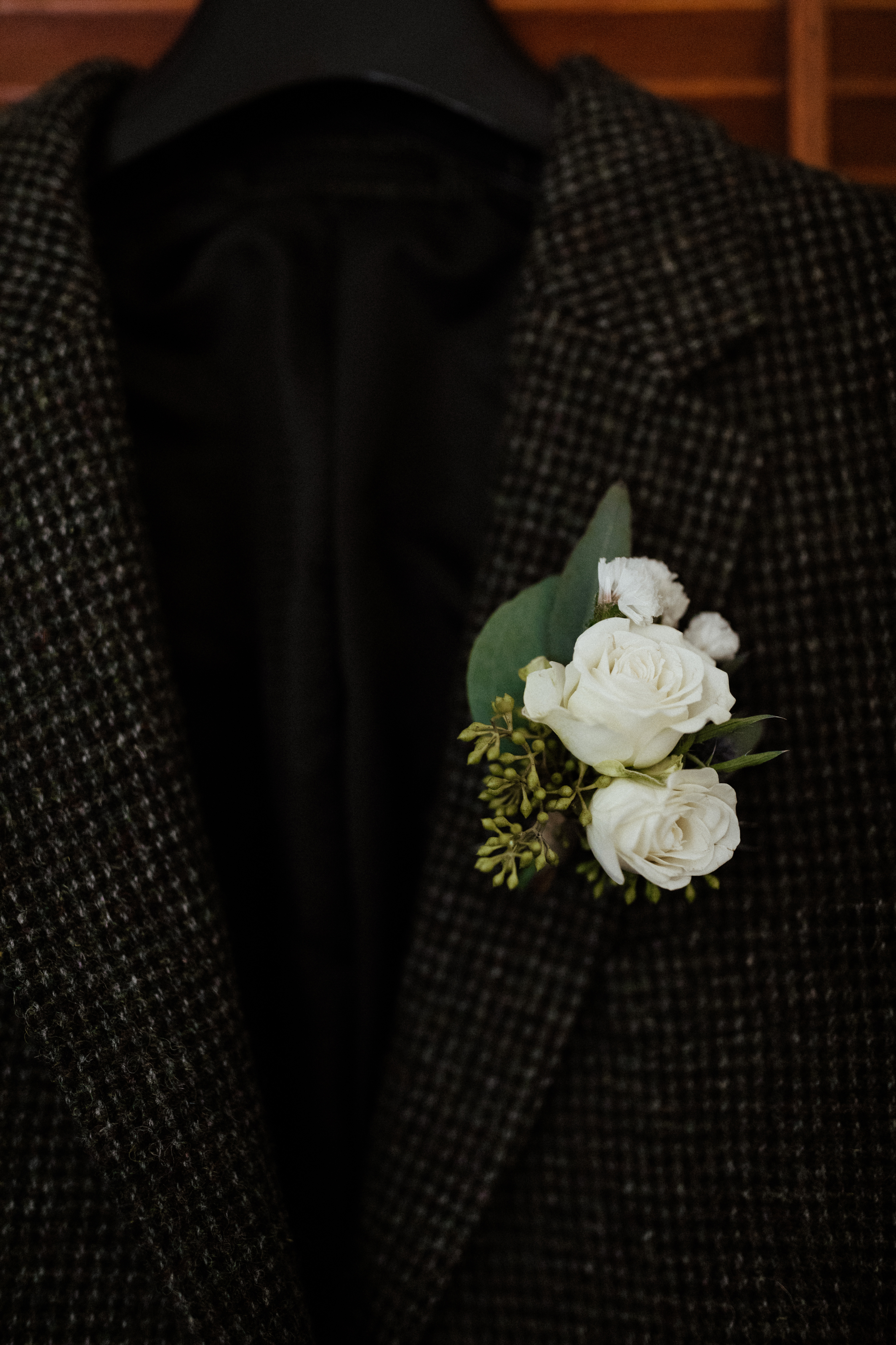 grooms tweed suit with florals on his elopement