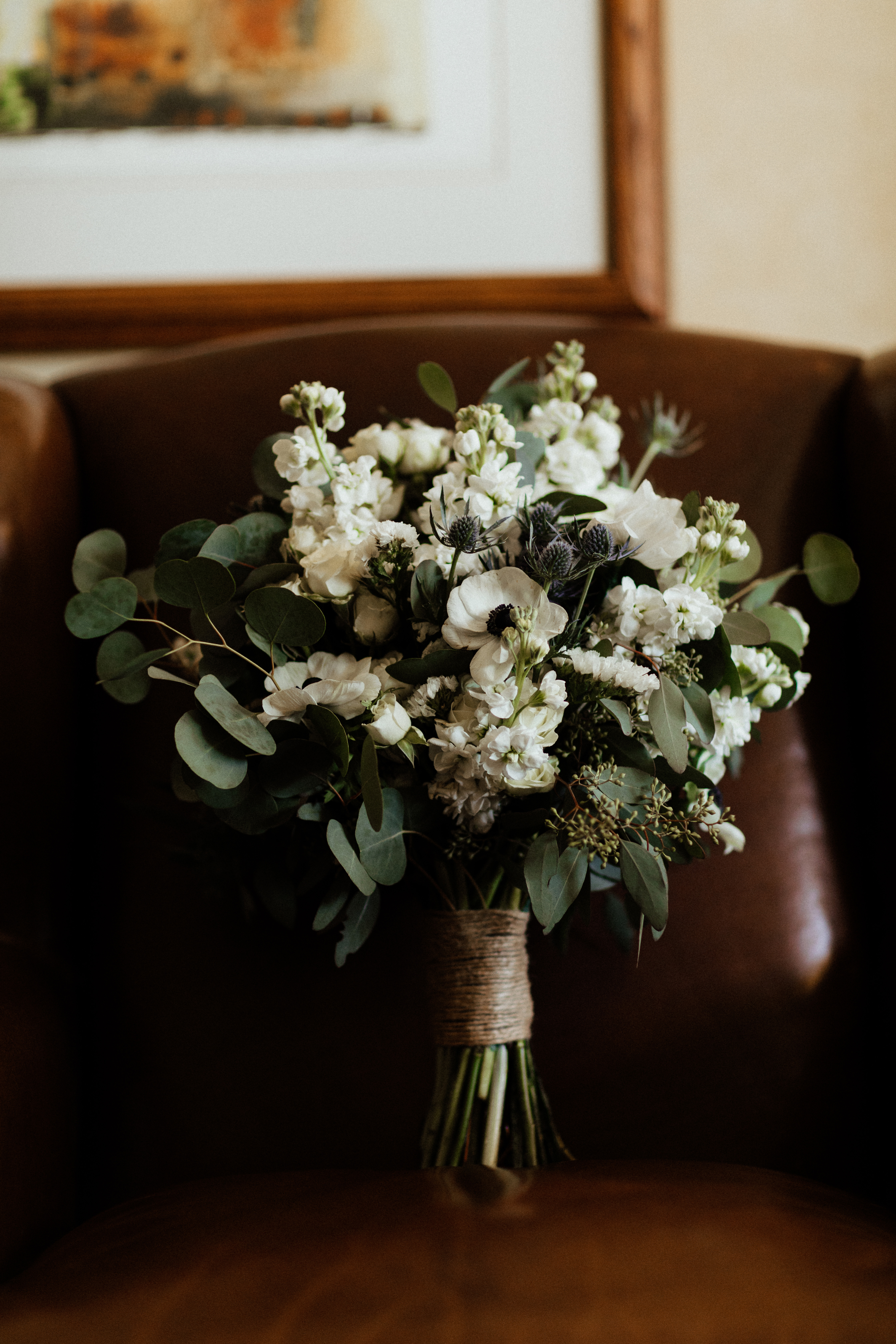 beautiful winter elopement florals on an old leather chair
