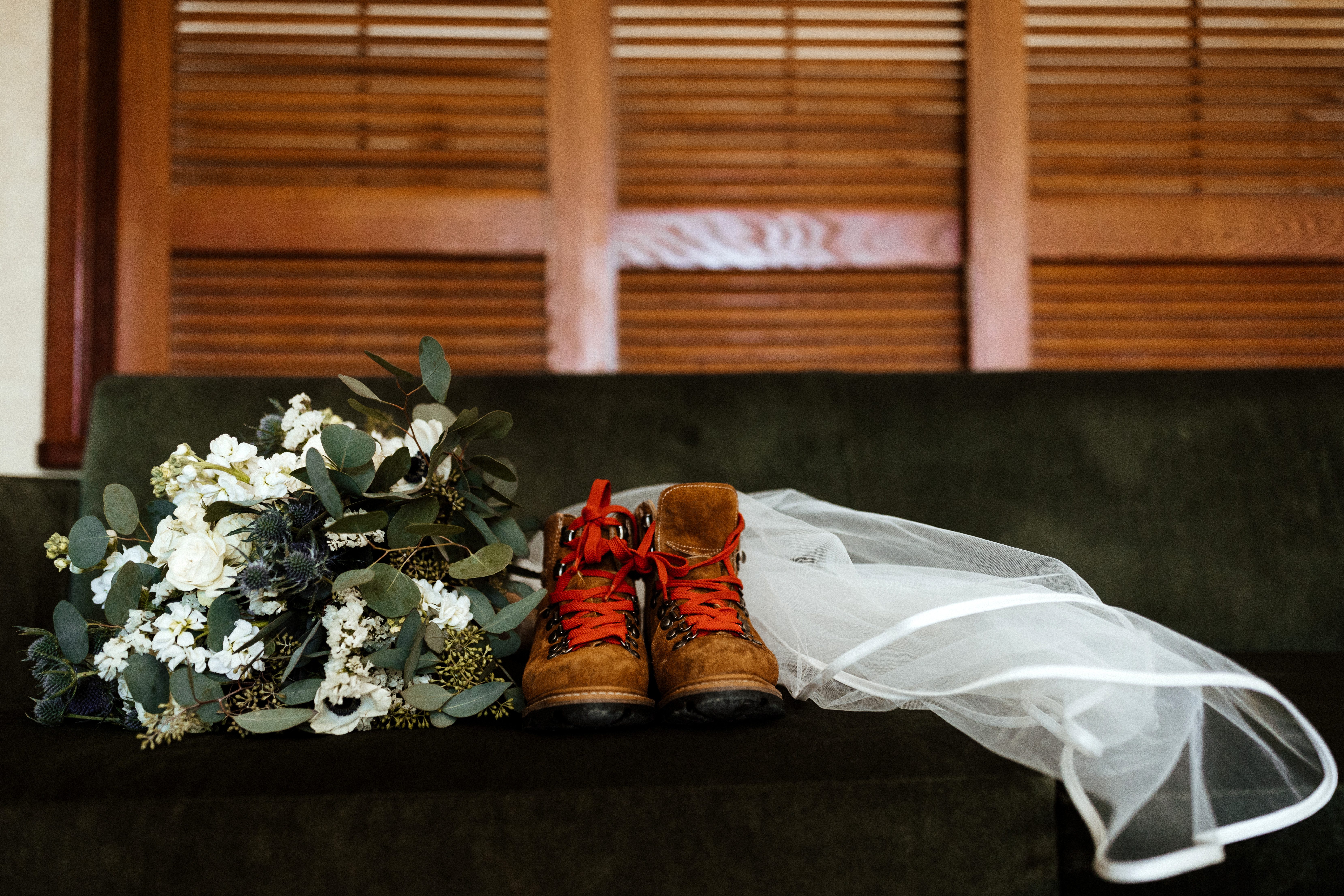 wedding bouquet and hiking boots brides elopement gear