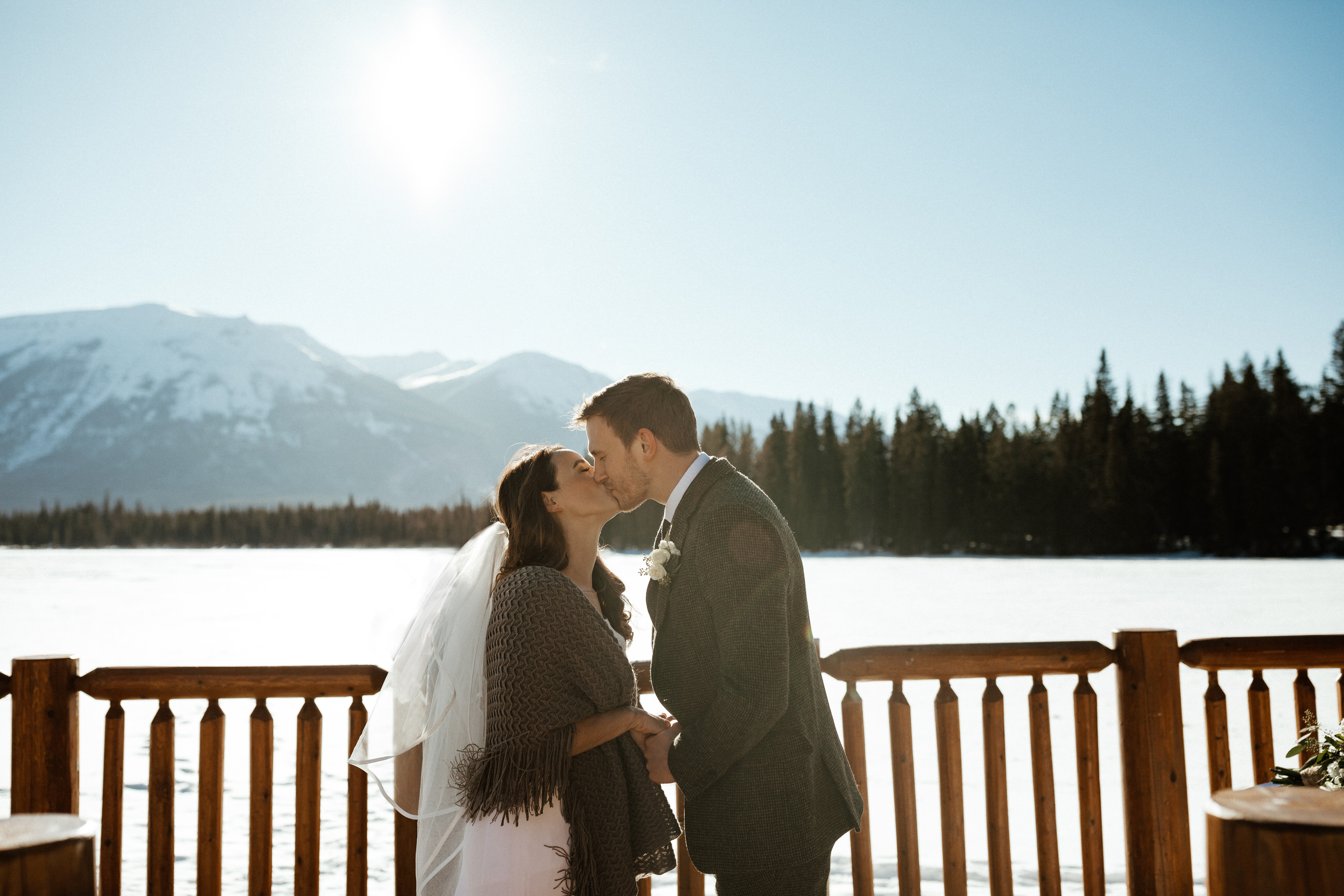 first kiss on their elopement in Jasper national park Alberta mountains
