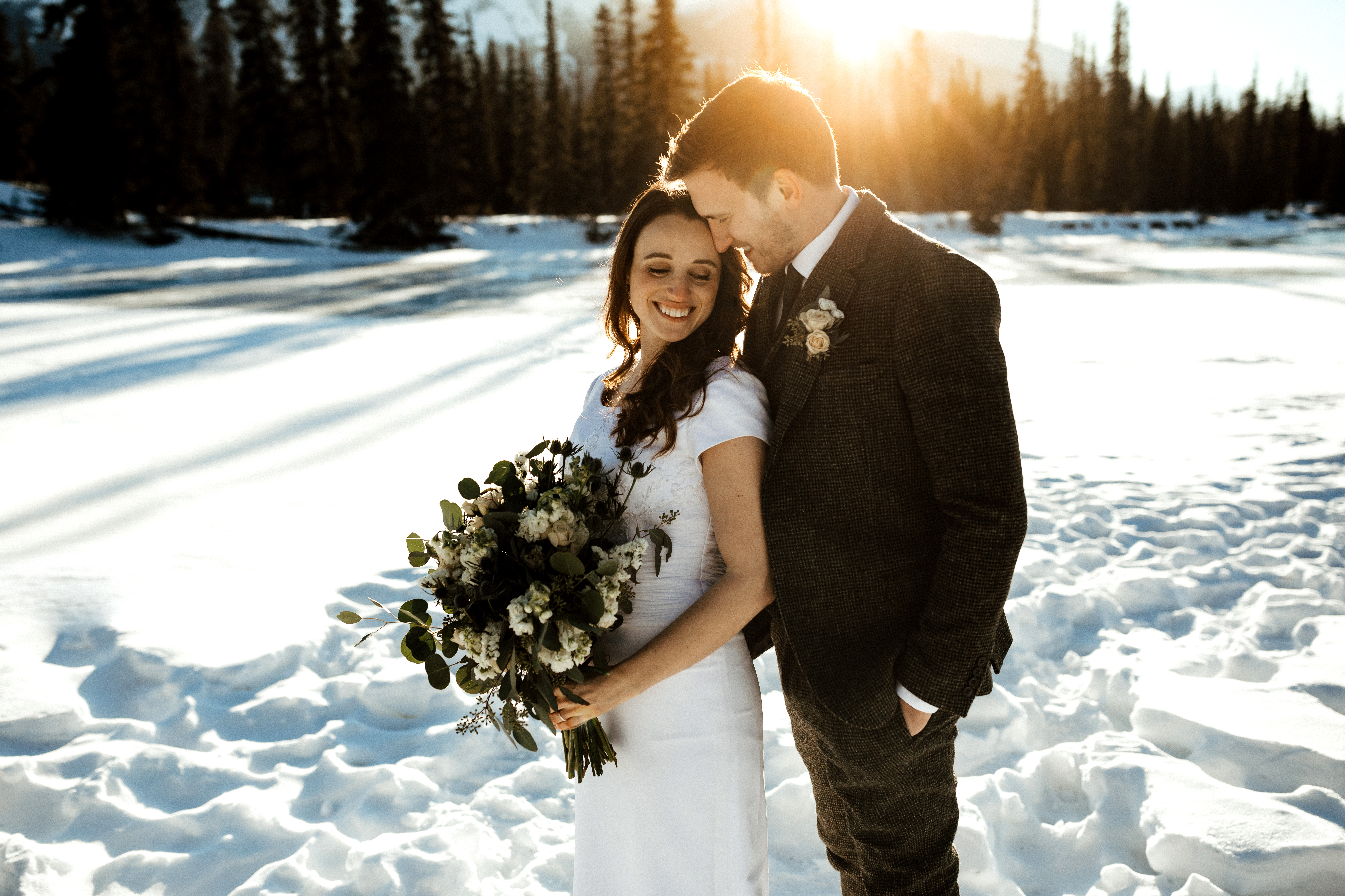 beautiful couple at sunset in the winter in Jasper Alberta on their wedding day