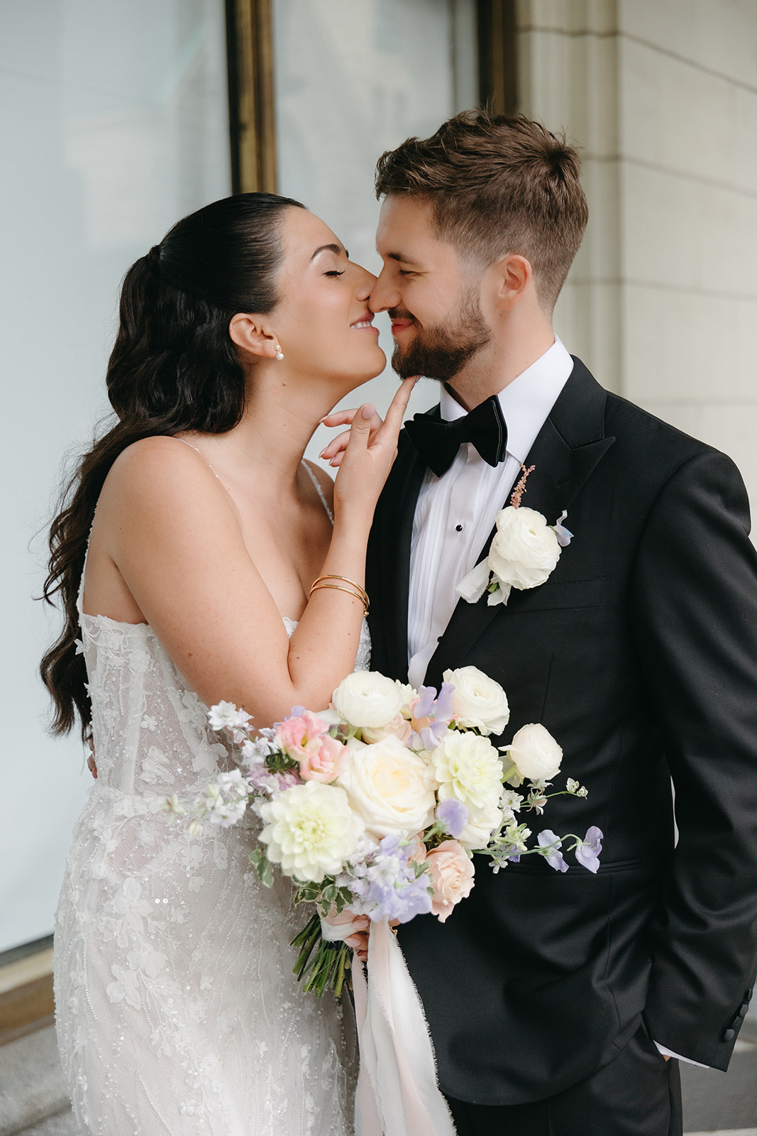 bride kissing groom in downtown calgary